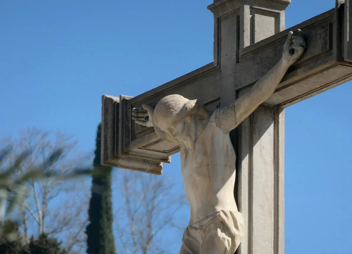 Cross against cloudy sky representing Good Friday significance