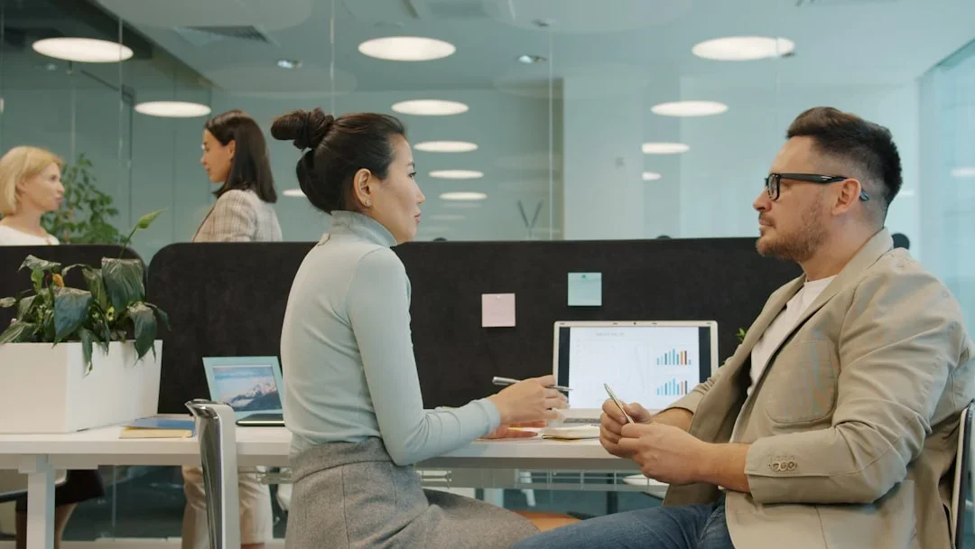 Professional meeting room with two people discussing salary negotiation