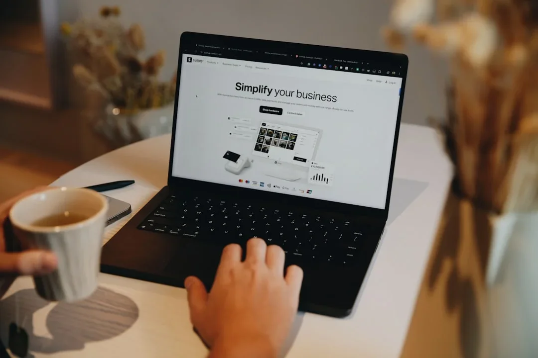 Small business owner using AI tools on laptop in modern office